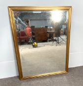 A large rectangular gilt framed mirror, with ogee frame and bevelled plate