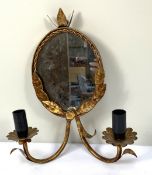A set of four vintage gilt metal two sconce wall lights, with oval mirrored backs and scroll arms;