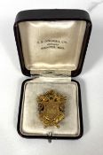 An Edwardian gold presentation winners badge, marked 10k, 9g, cased