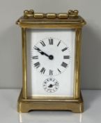 A brass cased carriage alarm clock, with four glass case, the enamel dial with subsidiary alarm