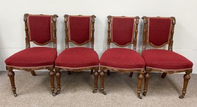 A set of four Victorian carved and padded dining chairs, late 19th century, with paterae carved