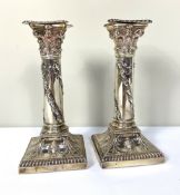 A pair of Edwardian silver squat Corinthian column candlesticks, hallmarked Sheffield, 1903,