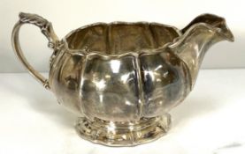 An Irish Victorian silver cream jug, Dublin, James Le Bas, 1848?, of lobed circular form with wavy