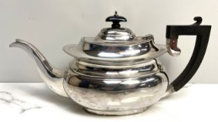 An modern silver teapot, of compressed oval form, hallmarked Birmingham, 1931, ebonized side