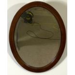 Four assorted modern mirrors, including a pine framed arched top wall mirror; an oval wall mirror