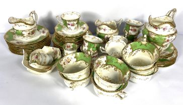 A Coalport bone china tea service, decorated with flowers and gilt decoration, with green ground,