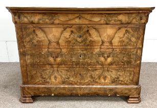 A Biedermeier walnut veneered commode, 19th century, with an ogee moulded frieze drawer over three