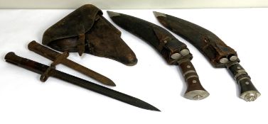 Two vintage Kukri, with sheaths and subsidiary knives, also a vacant wartime pistol holster and