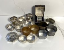 Eight assorted silver napkin rings, various dates and makers, including one case, 187g; also