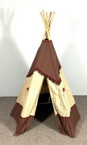 A small novelty child’s Teepee, with six supports and a decorative cover decorated with emblems