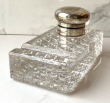 An Edwardian silver and cut glass desk inkwell, hallmarked London, date obscured, with a hinged well