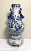 A Chinese blue and white vase and matching base, modern, decorated in underglaze glue with Dragons