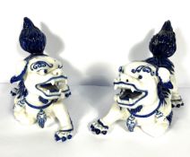 A pair of modern Chinese blue and white Qilin (Lions), Qing Style, in dramatic poses