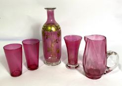 A group of cranberry glassware, including a gilt decorated baluster shaped bottle, also a jug,