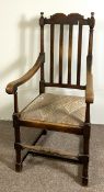 A vintage Jacobean style beech wood framed armchair