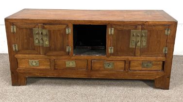 A modern Chinese hardwood (Nanmu) side cabinet, with brass mounts, and four short drawers on block