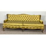 A large French style button upholstered settee, 20th century, with serpentine padded back and