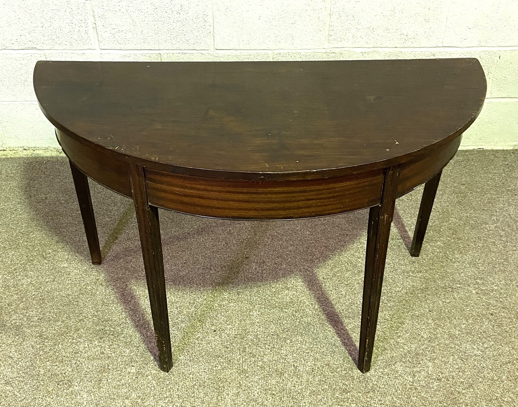 A Regency style demi lune side table; 125cm wide by 58cm deep