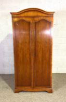A Georgian reproduction two door wardrobe, with arched top