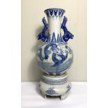 A Chinese blue and white vase and matching base, modern, decorated in underglaze glue with Dragons