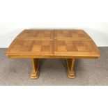 An Art Deco style extending dining table, with a single additional leaf, with 'chequered' top and