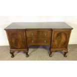 A George III style breakfront mahogany veneered sideboard, the plain top with a moulded edge, over