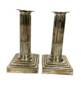 A pair of George III silver desk column candlesticks, hallmarked London 1774, of typical form,