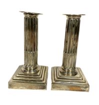 A pair of George III silver desk column candlesticks, hallmarked London 1774, of typical form,