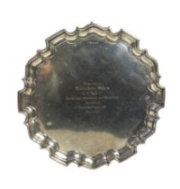 A silver presentation salver, hallmarked Sheffield 1938, of typical circular form on three scroll