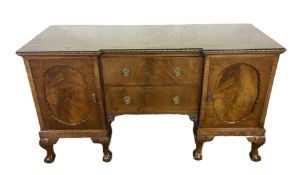A George III style breakfront mahogany veneered sideboard, the plain top with a moulded edge, over