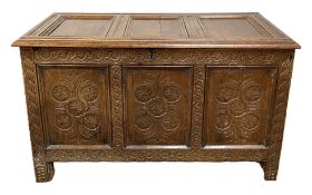 A Charles II oak coffer, late 17th century and later, with a three panelled and hinged top, the
