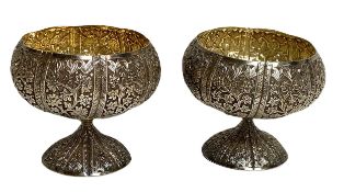 A finely chased pair of Indian white metal sweetmeat bowls, circa 1900, each in the form of a
