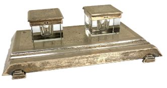 A silver inkstand, hallmarked Birmingham, 1938, of rectangular engine turned form, set with two