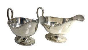 A pair of Regency style silver sauceboats, hallmarked Chester 1910,  of typical oval dished form,