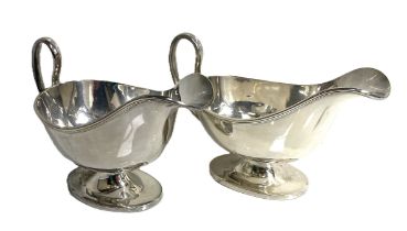 A pair of Regency style silver sauceboats, hallmarked Chester 1910,  of typical oval dished form,