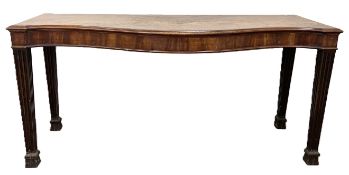 An impressive George III mahogany serpentine serving table, circa 1790, with a moulded shaped top