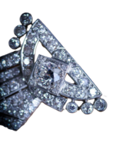 An Art Deco Diamond Brooch, circa 1925,  of scrolling ribbon form, set with a single and round