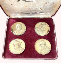 A commemorative set of four silver gilt crowns, celebrating Winston Churchill,  designed by John