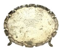 A silver presentation salver, hallmarked London, 1934, of typical circular pie crust form, with four