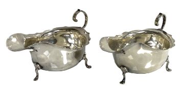 A pair of silver sauceboats, hallmarked Chester 1915, of typical dished form, with scroll side