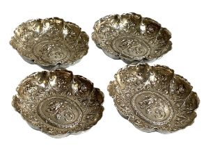 A set of four Victorian silver sweetmeat trays, London 1892/1894, of oval lobed form, deeply