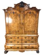 An impressive Dutch walnut armoire, early 19th century,  with an arched and moulded cornice, centred