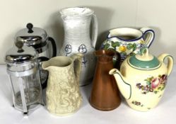 A collection of assorted ceramics, including jugs, two cake dishes, an oval ashet and other items (a