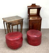 A pair of red ‘leathered’ footstools; together with a beech nest of tables and a late Victorian