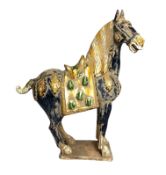 A Chinese Tang style horse, 20th century, glazed pottery, decorated in colours, 68cm high