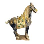 A Chinese Tang style horse, 20th century, glazed pottery, decorated in colours, 68cm high