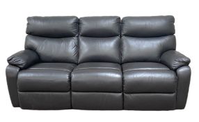 A modern three seat black leather reclining sofa, with two adjustable foot rests