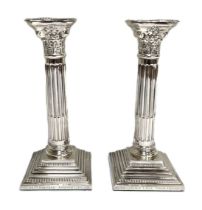 A pair of silver Corinthian column style candlesticks, hallmarked Birmingham 1998, of typical