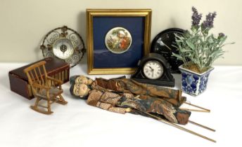 A collection of miscellaneous items, including two clocks, a decorative pot lid, oriental puppets