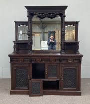 A large late Victorian oak sideboard, circa 1890, with the stepped and mirrored gallery back over